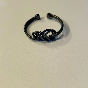 Adjustable Guess bracelet in charcoal gray. Fits small wrist.